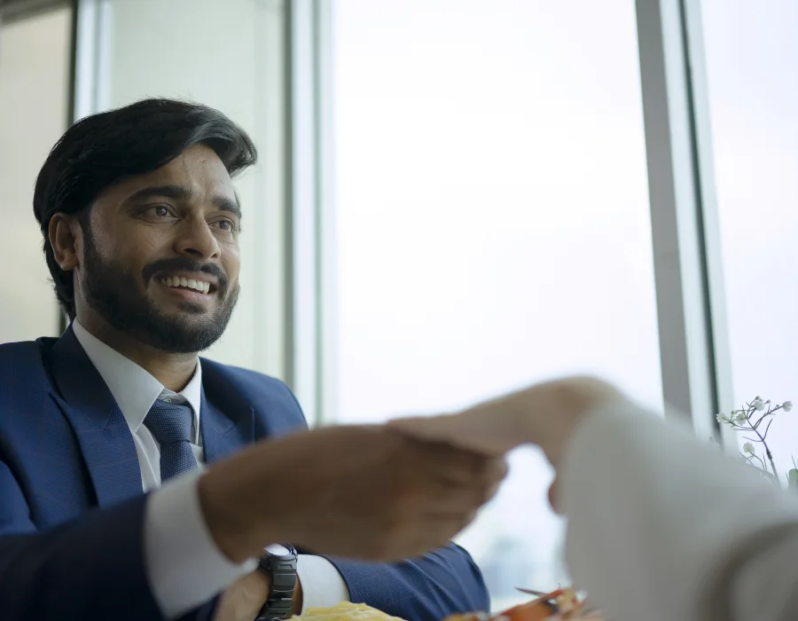 Consultant shaking hands with a new distributor after a sales planning meeting