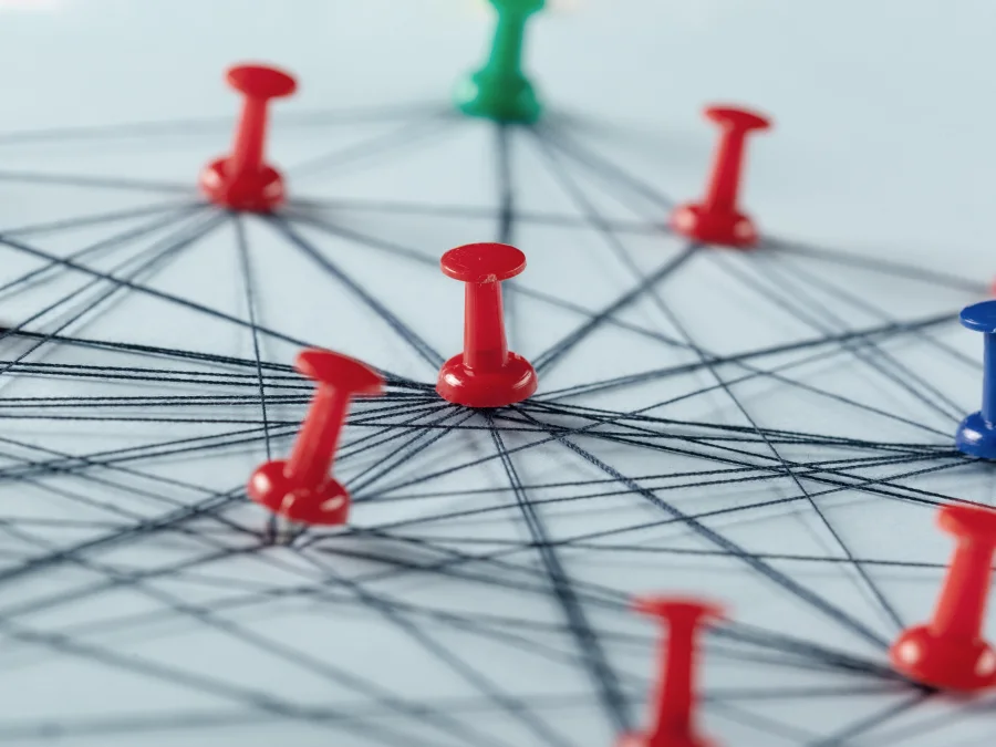 Red and blue pins connected by threads into a network